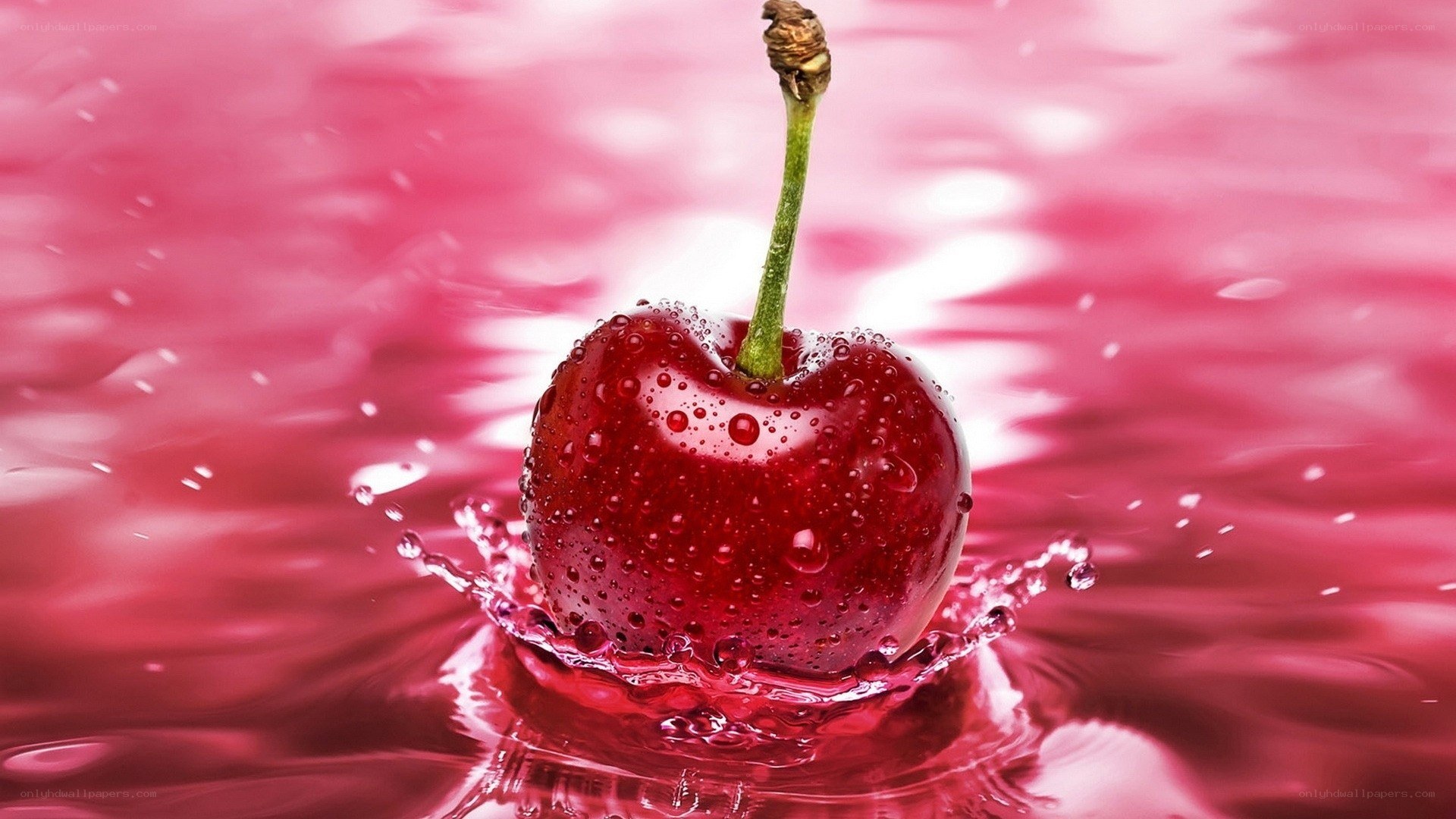 Cherry splashing in red liquid