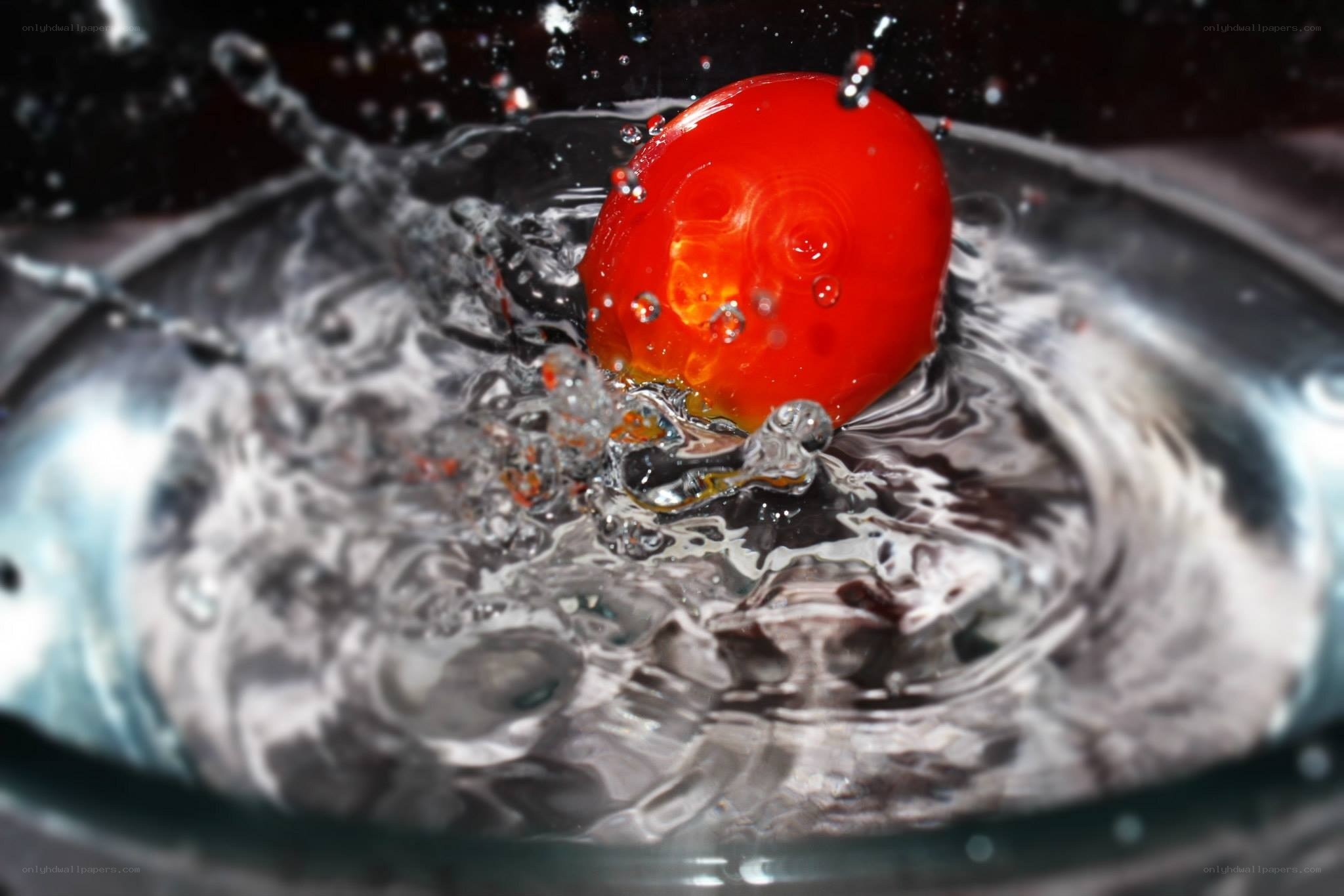 cherry tomato splashing in water