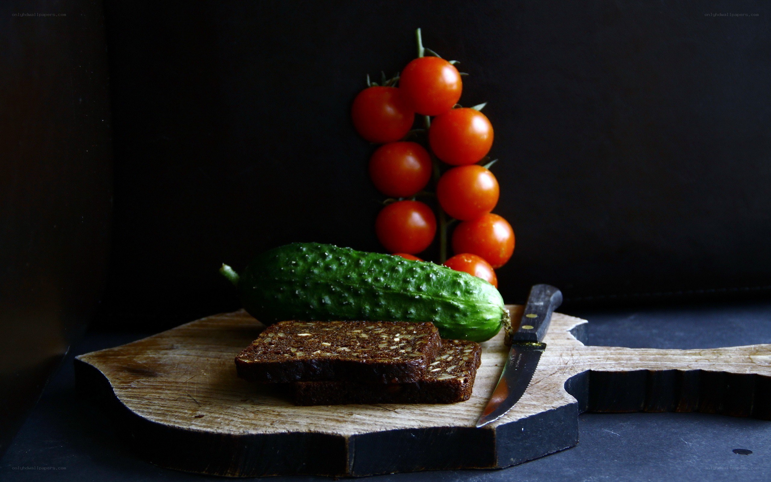 Cherry tomatoes and cucumber on board