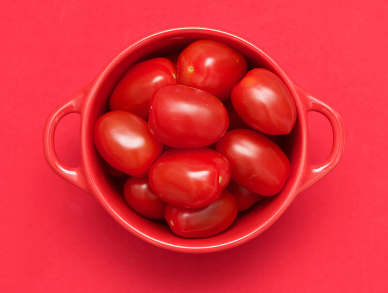 Cherry tomatoes in a red bowl