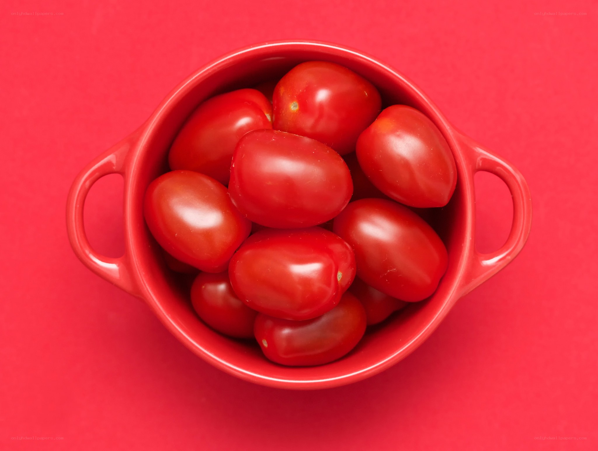 Cherry tomatoes in a red bowl