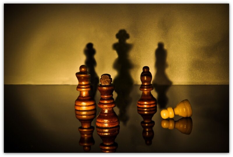 chess pieces in dramatic lighting