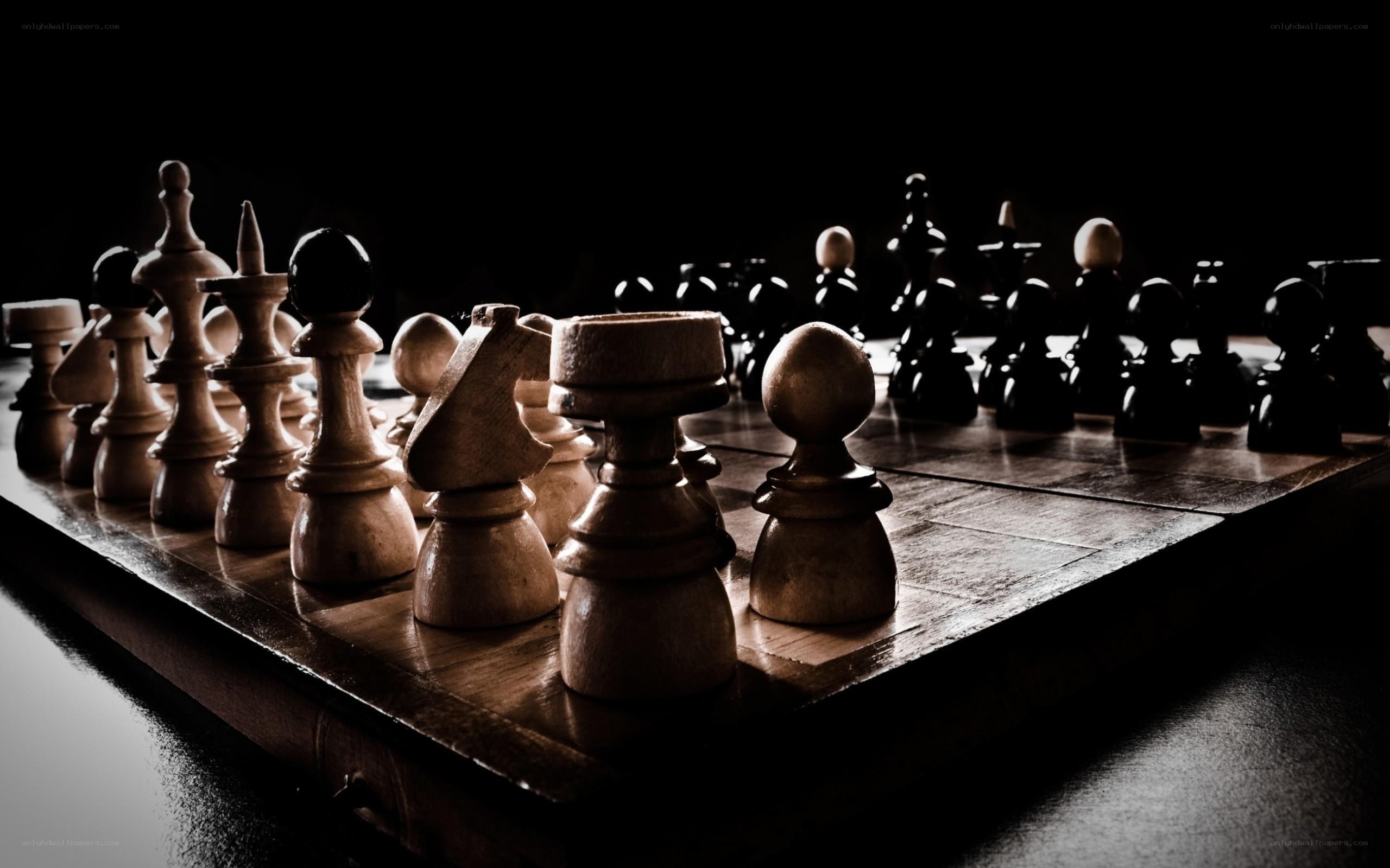 chess pieces on a dark board
