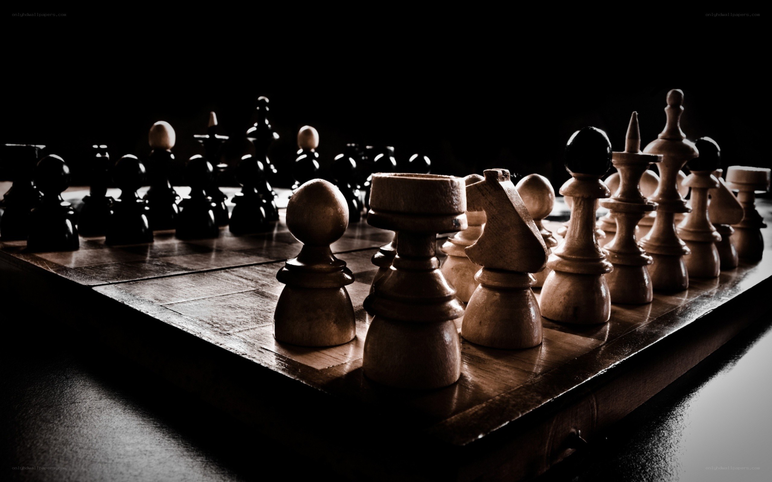 chess pieces on a dark board