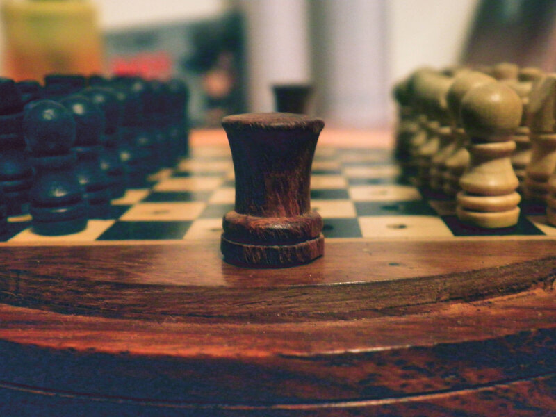 chess pieces on a wooden board
