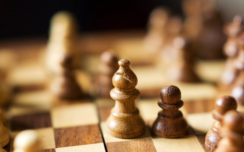 chess pieces on a wooden board