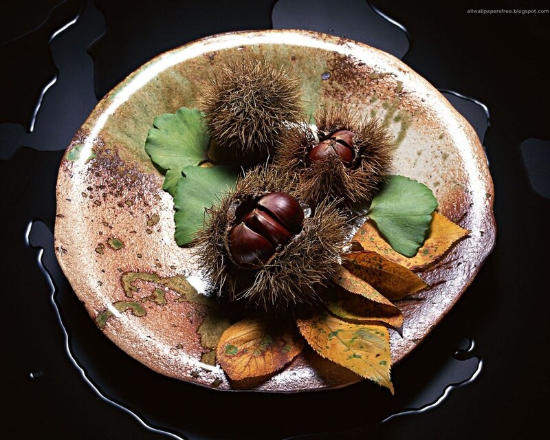 Chestnuts and leaves in a bowl