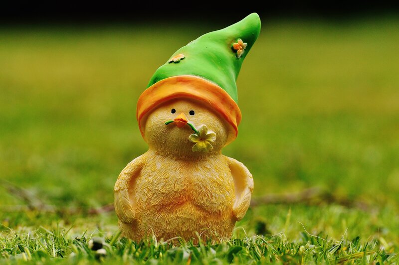 chick figurine in garden