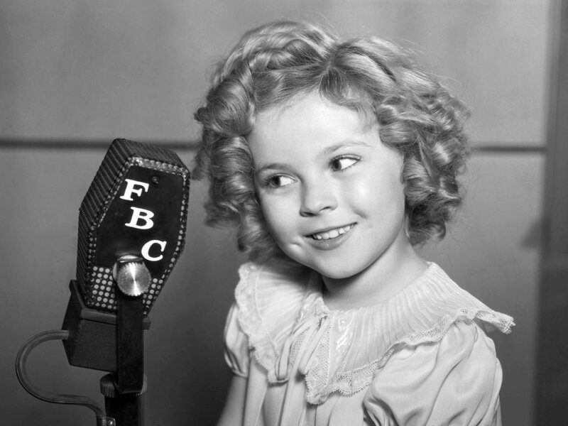 child actress at a microphone