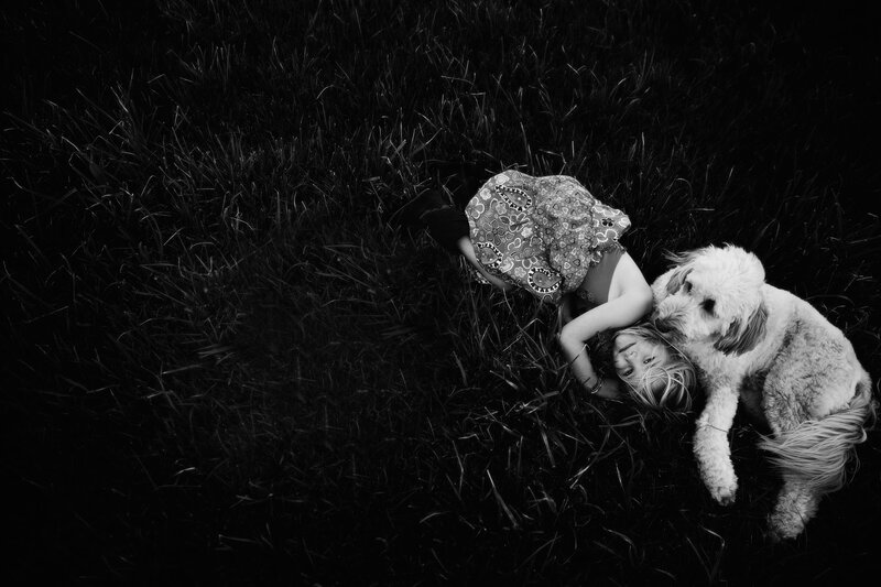 Child and Dog in Grass — Black
