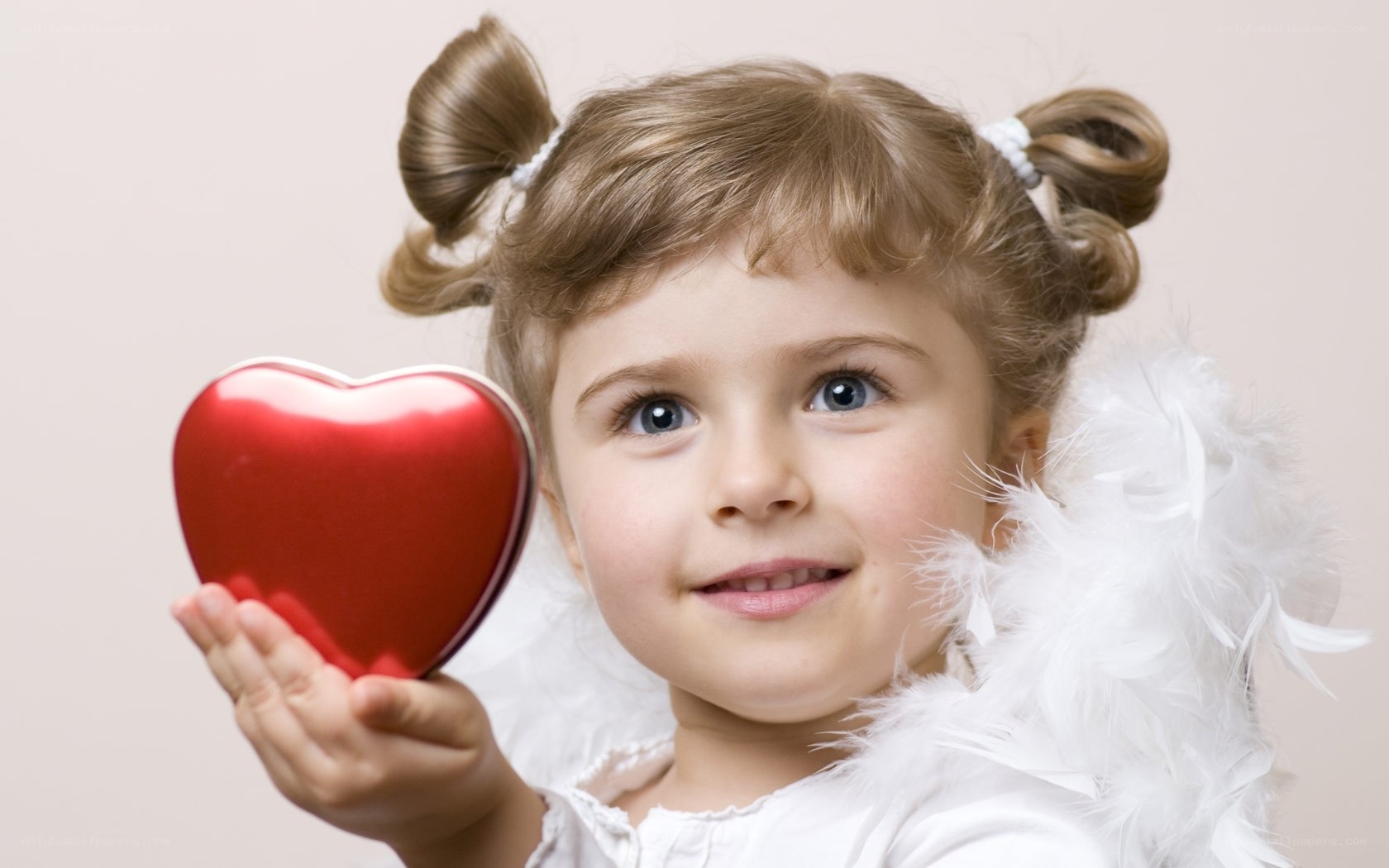 child angel holding red heart