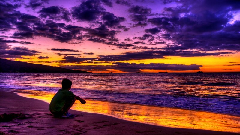 Child at beach during sunset