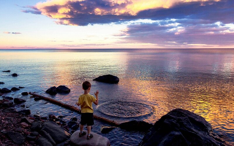 Child at sunset by the water