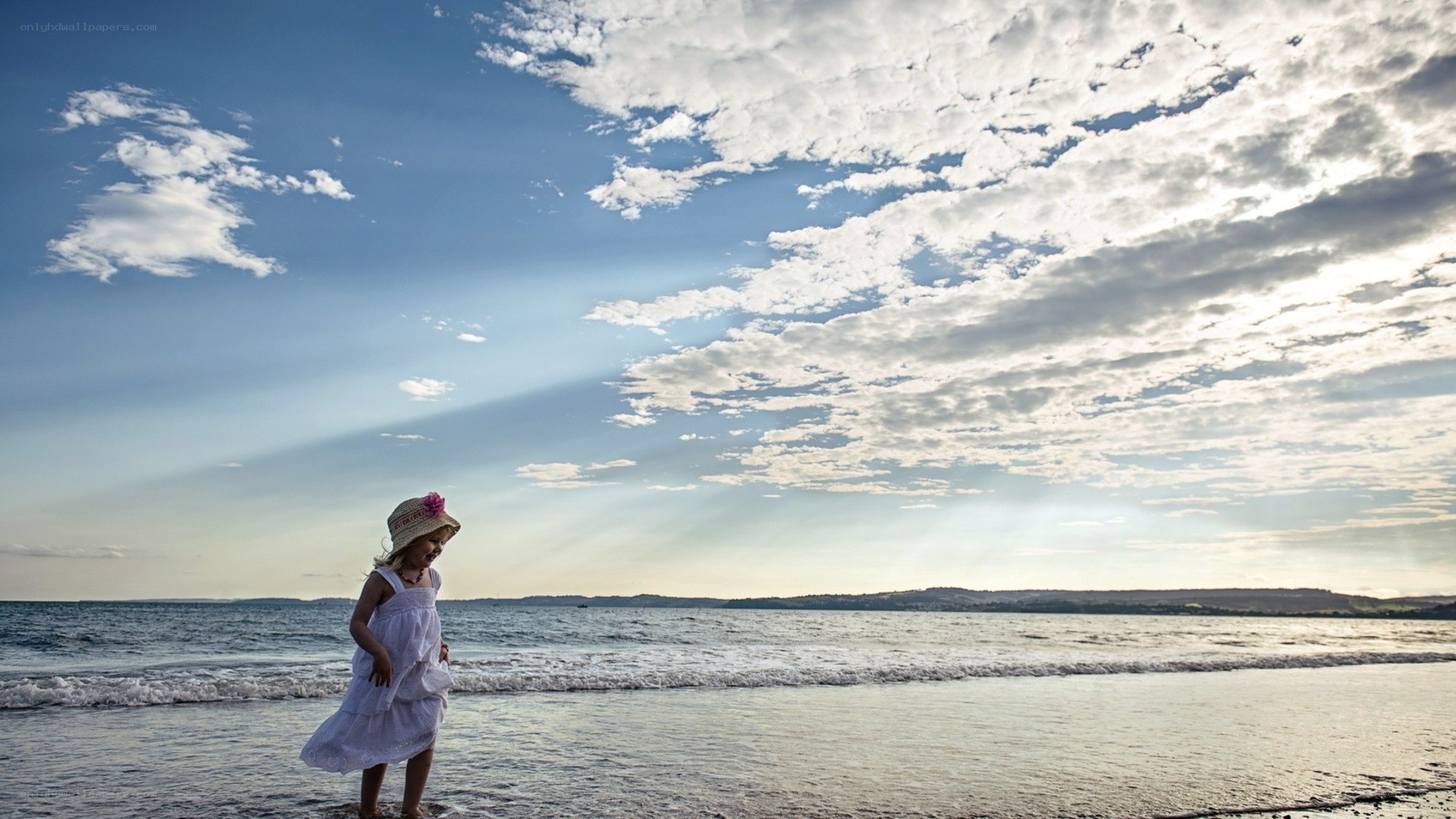Child at the beach at sunset