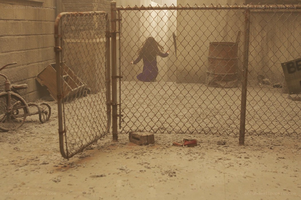 Child behind a chain-link fence