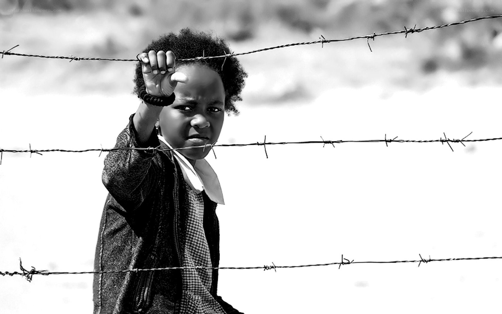 child behind barbed wire