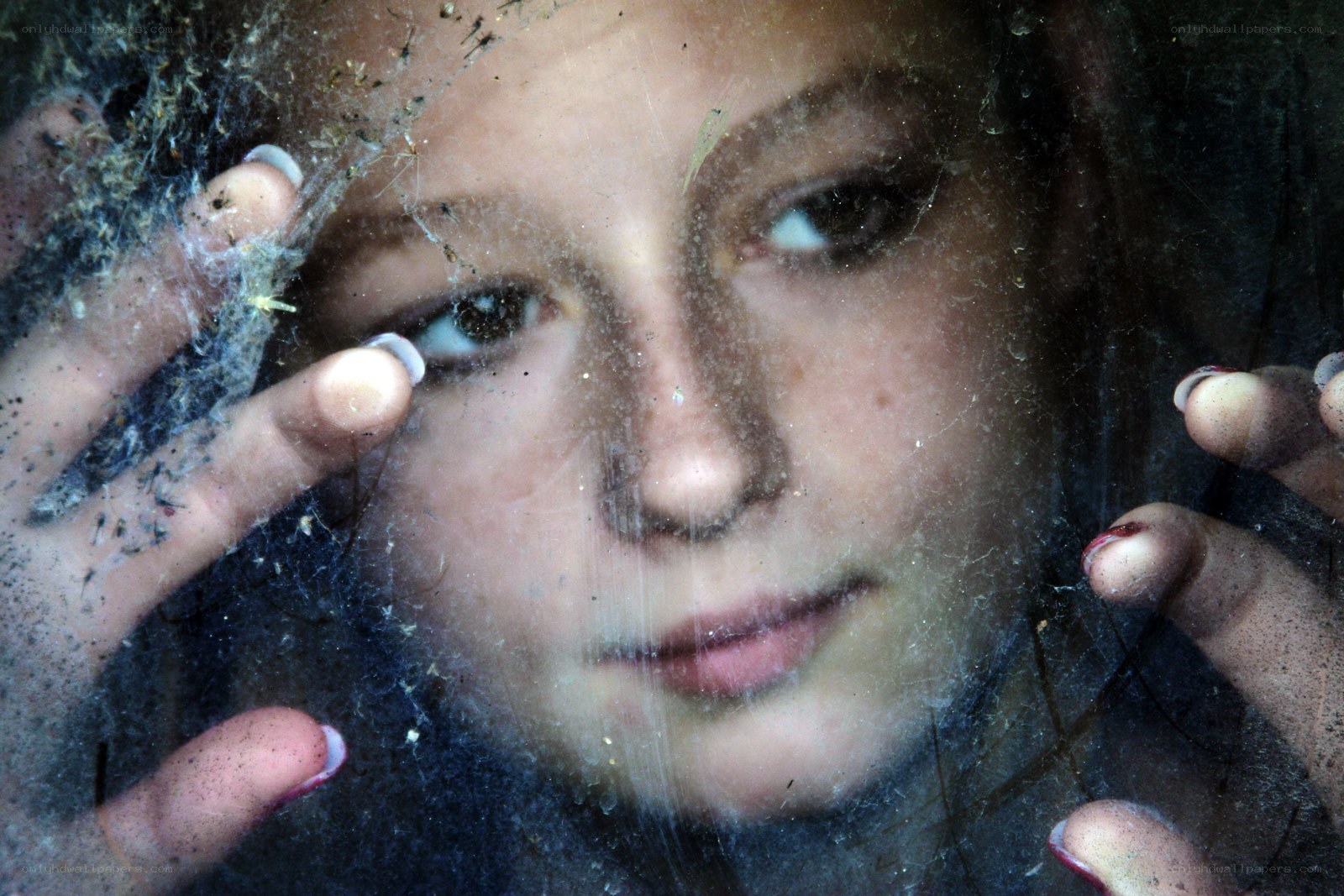 child behind dusty glass