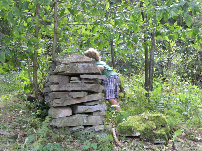 Child Behind Stone Wall