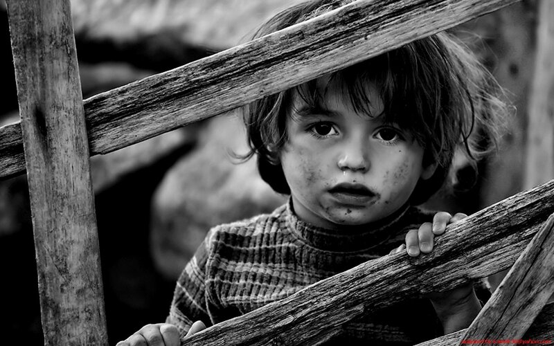 child behind wooden fence