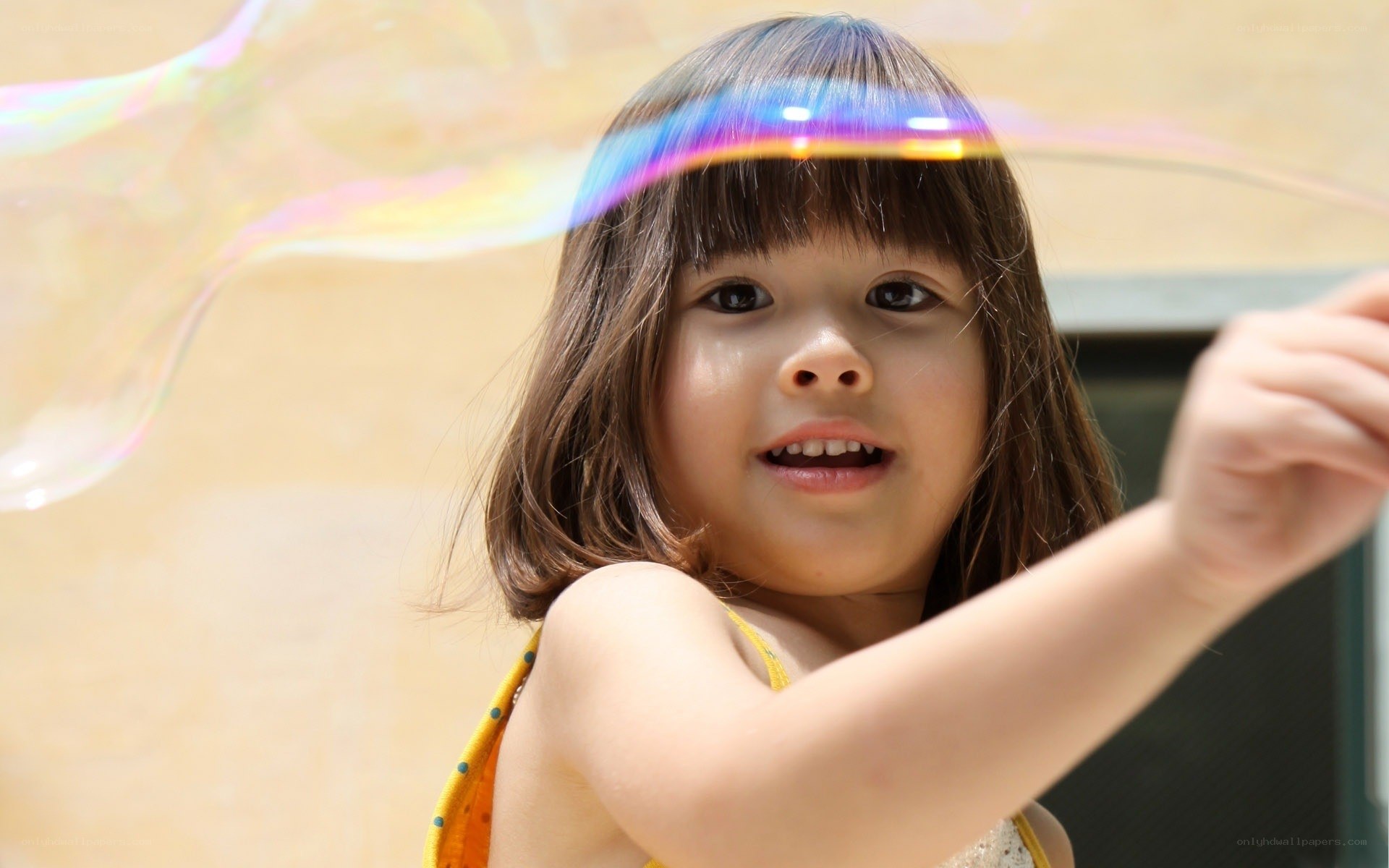 child blowing a bubble