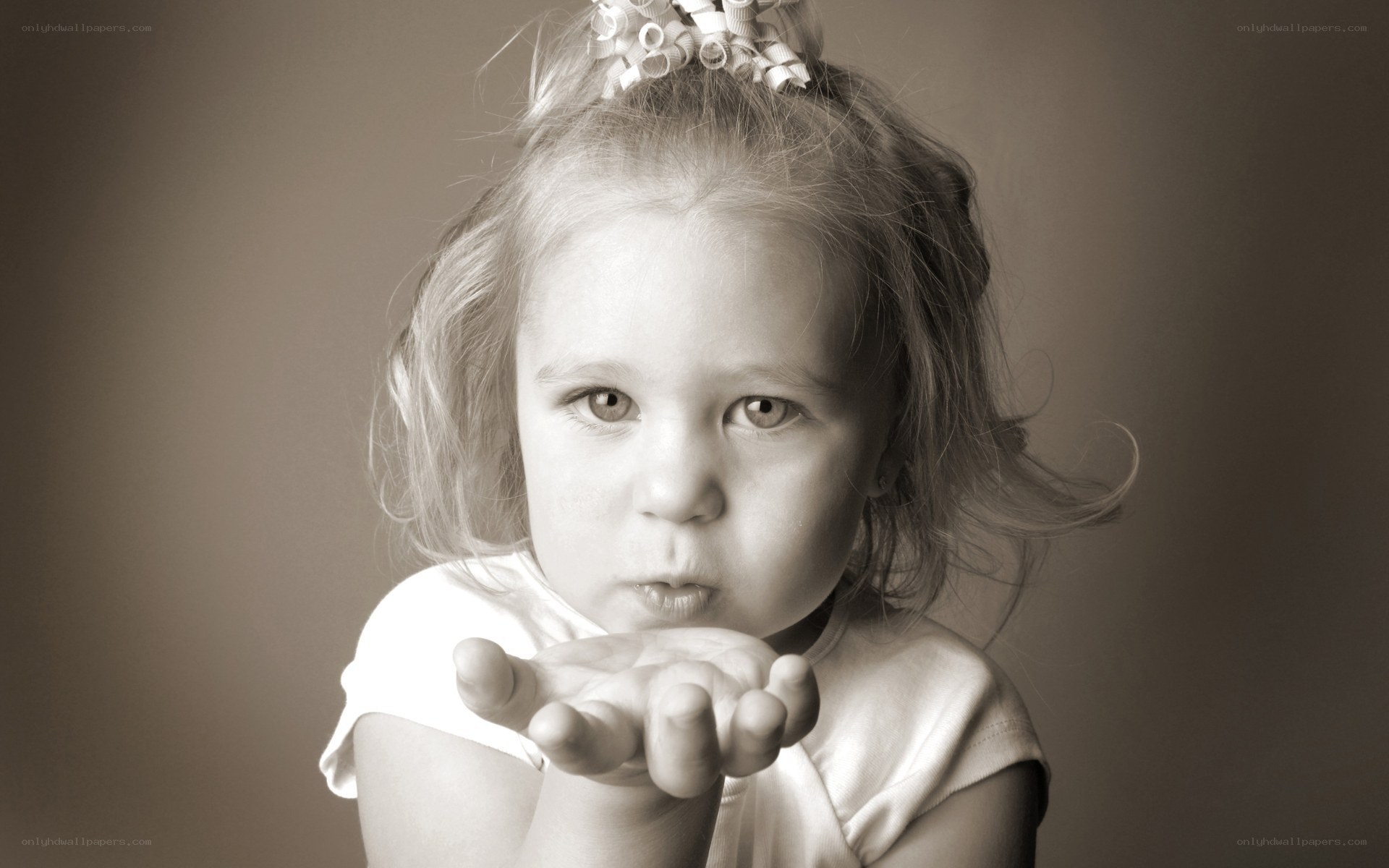 child blowing a kiss