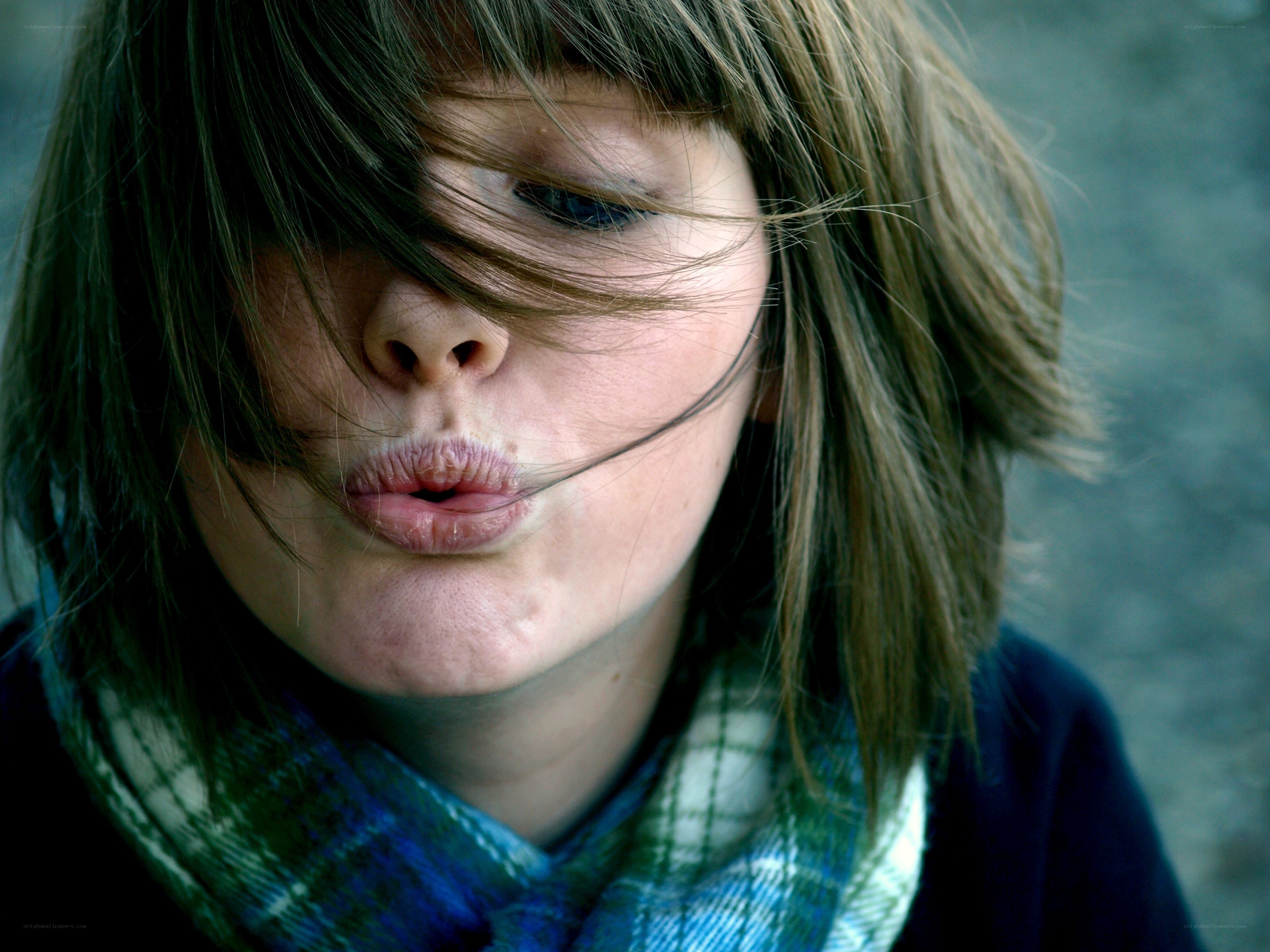 child blowing a kiss
