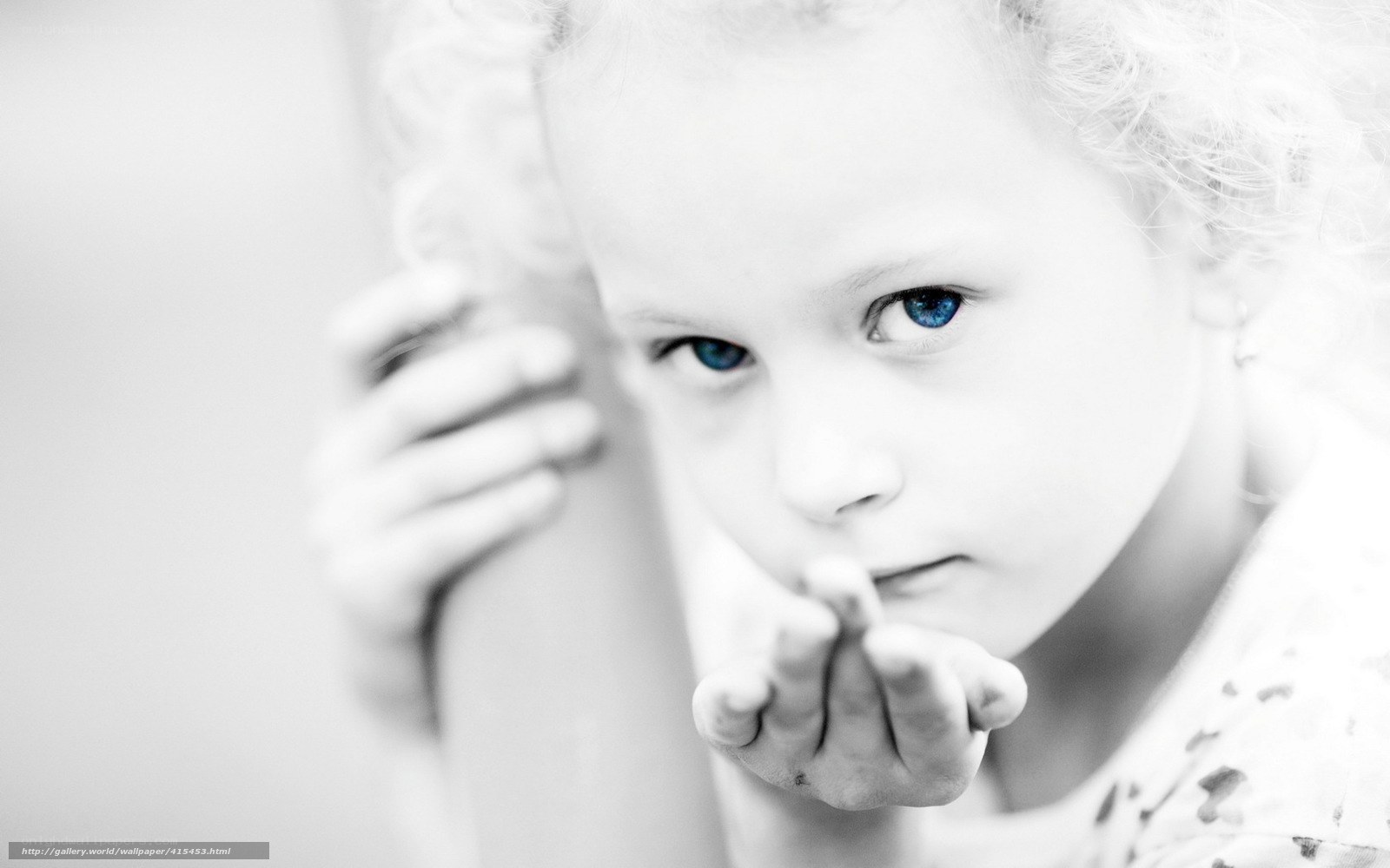 child blowing a kiss