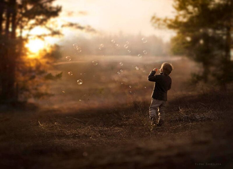 Child Blowing Bubbles — Brown, Serene