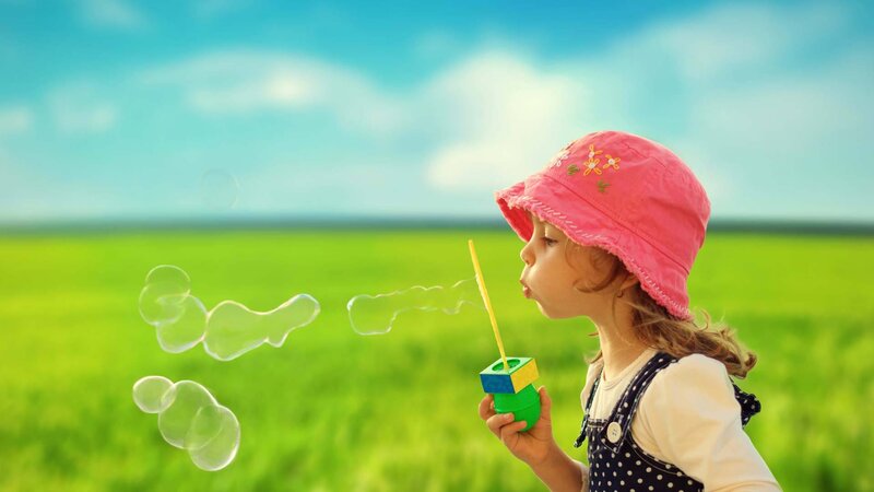 Child Blowing Bubbles — Green, Serene, Afternoon