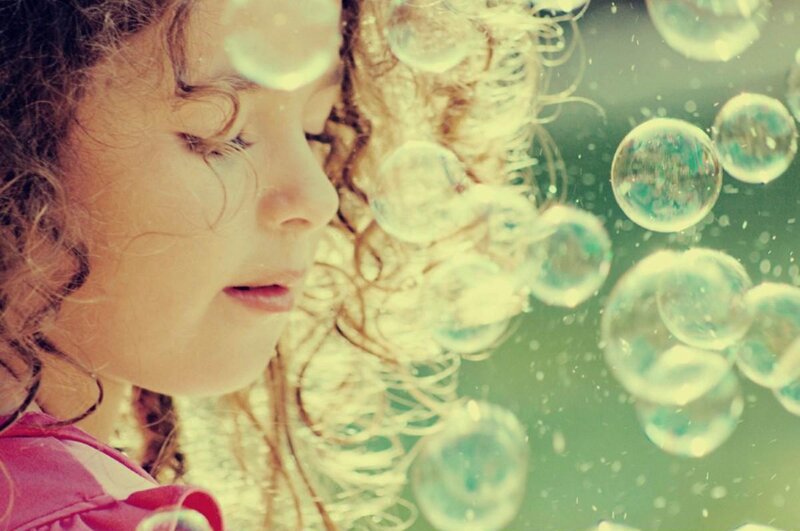 Child Blowing Bubbles — Green
