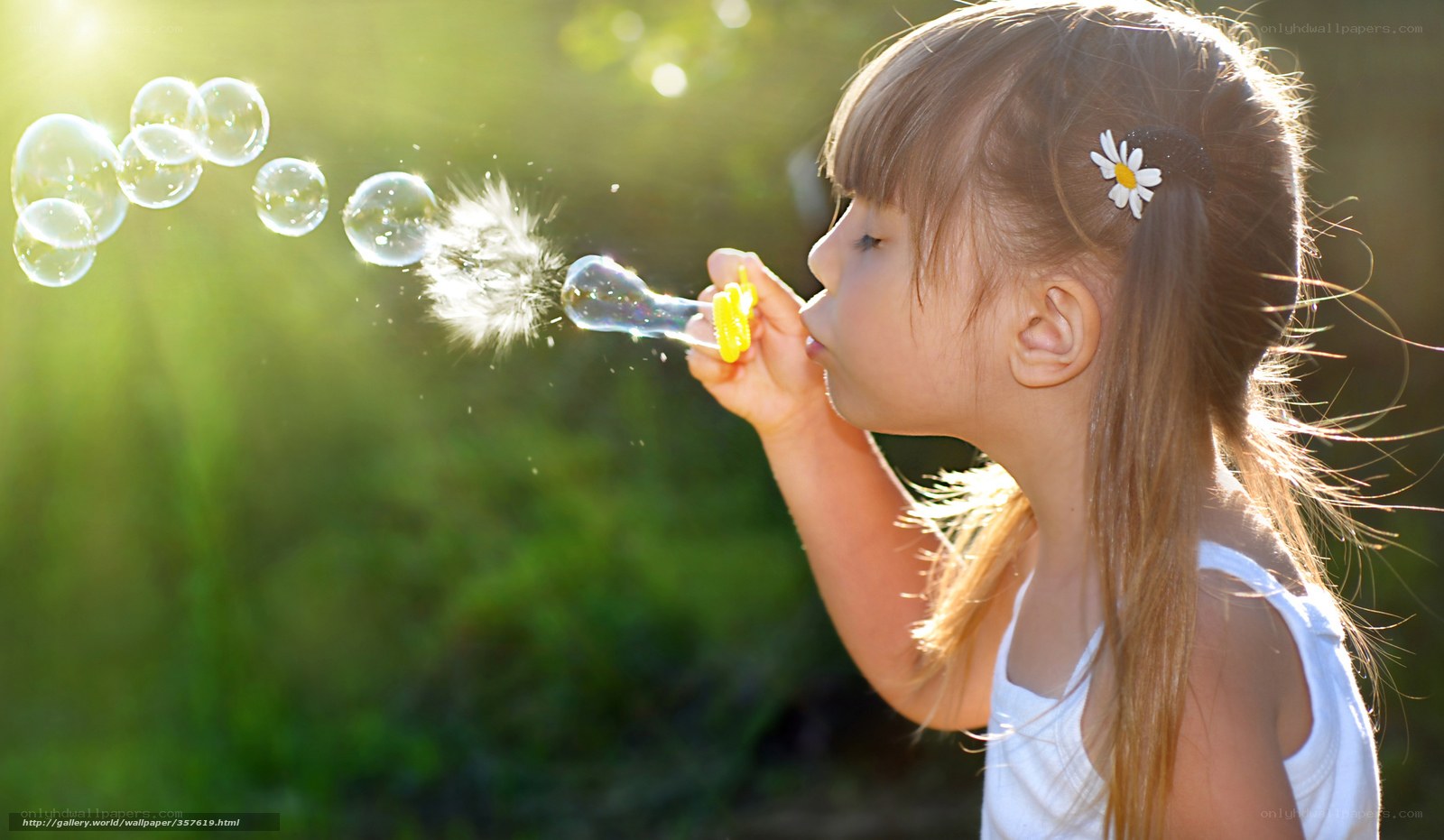 child blowing bubbles in sunlight