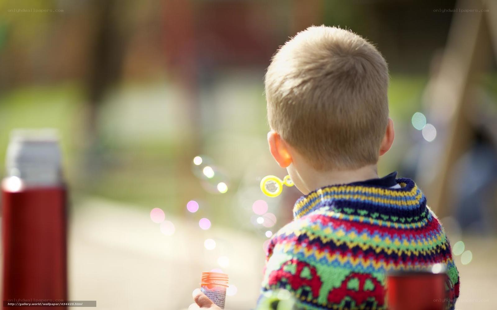 child blowing bubbles outdoors