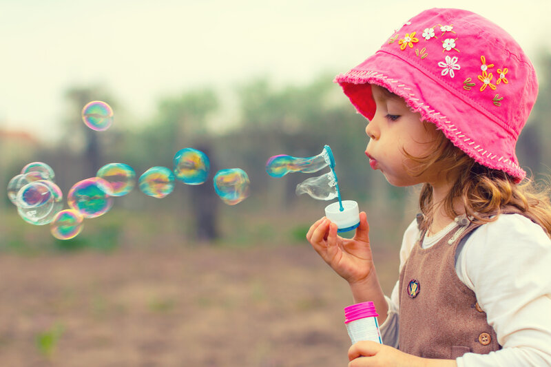Child Blowing Bubbles — Pink, Playful