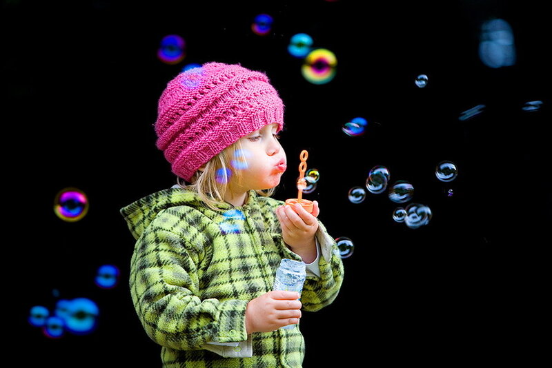 Child Blowing Bubbles — Pink