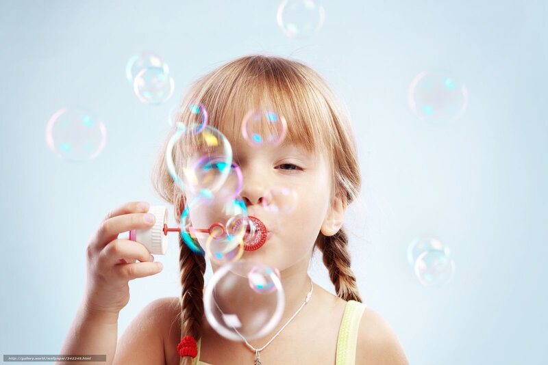 child blowing bubbles
