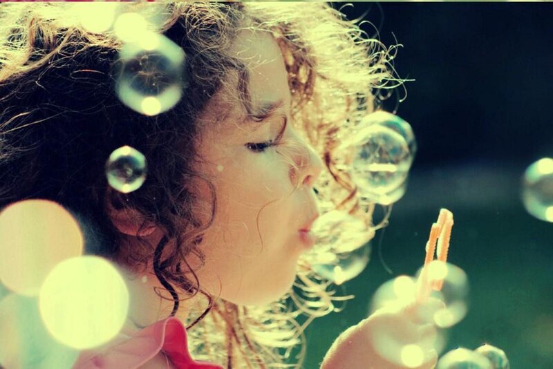 Child Blowing Bubbles — Yellow