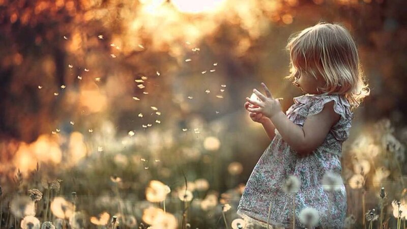 Child Blowing Dandelion — Golden
