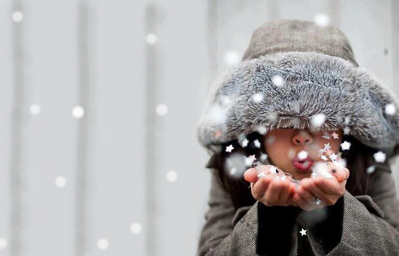Child Blowing Snowflakes