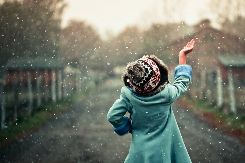 child catching snowflakes