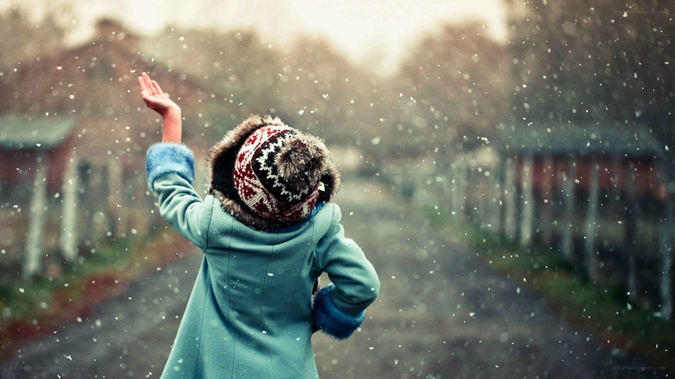 child catching snowflakes