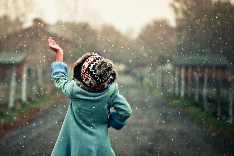 Child catching snowflakes