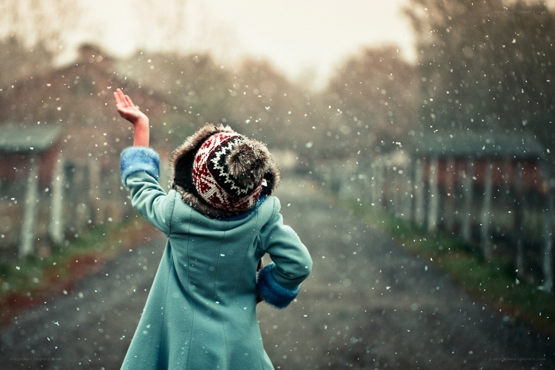 Child catching snowflakes