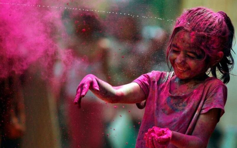 child celebrating holi festival
