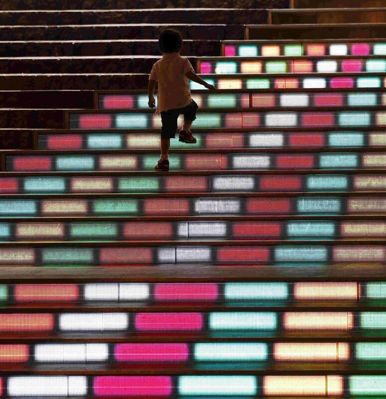 child climbing colorful stairs