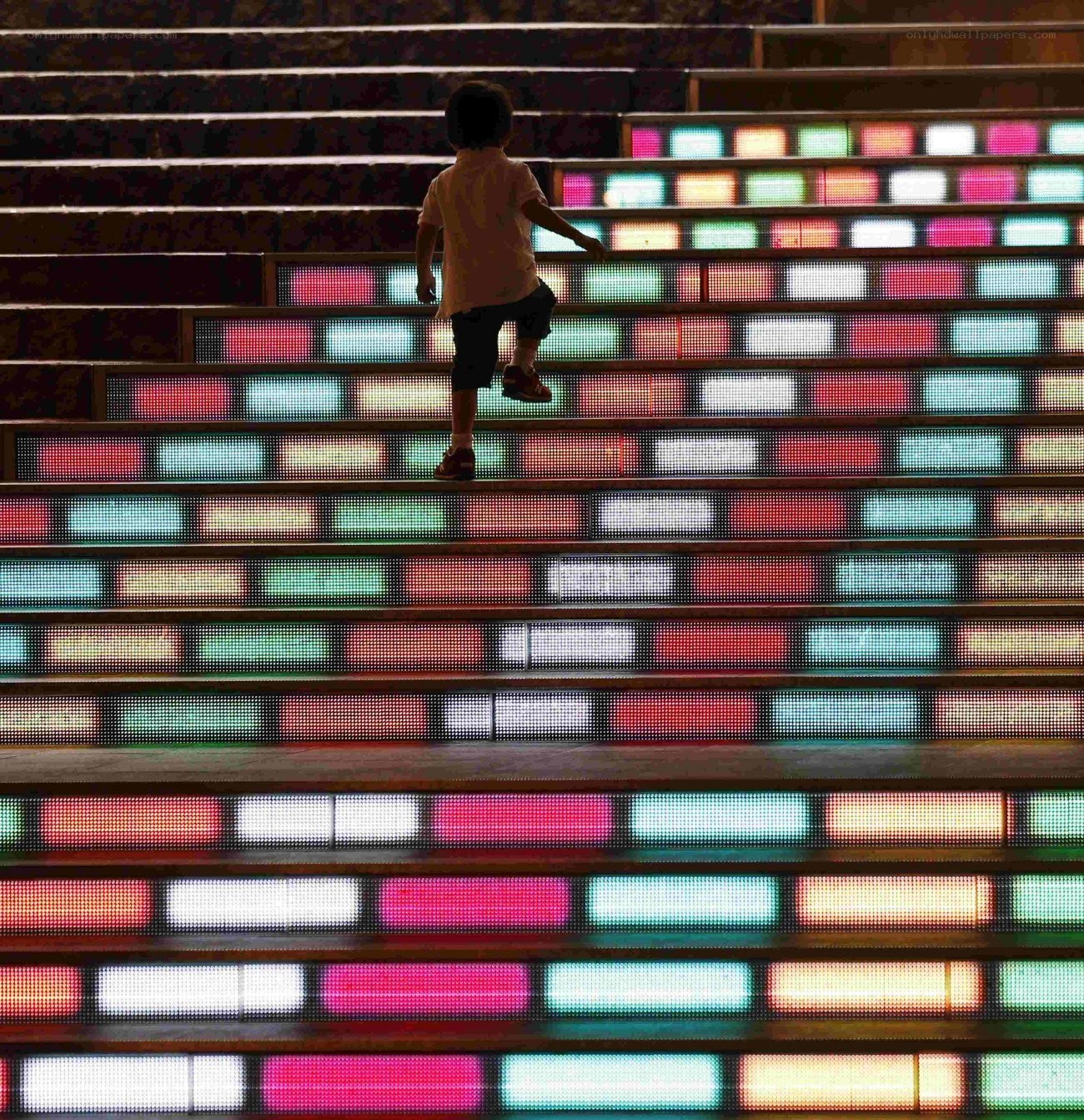 child climbing colorful stairs