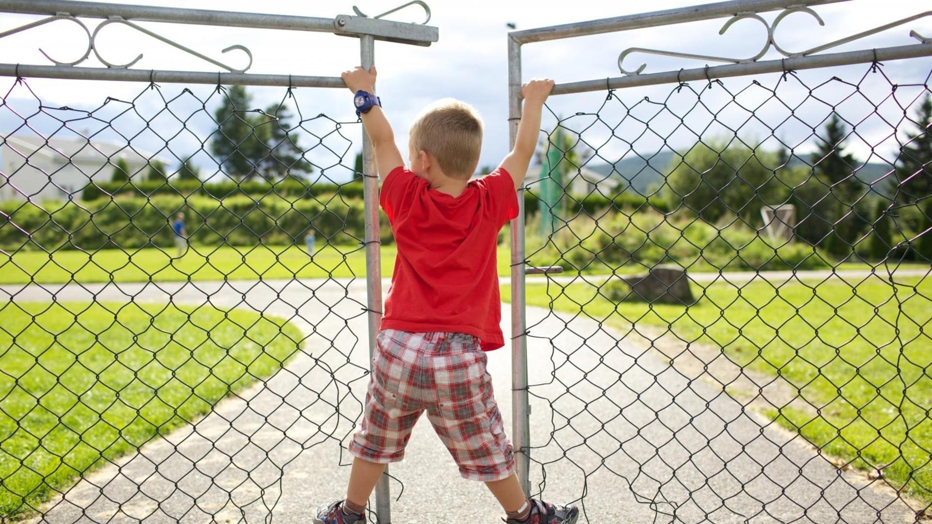 child climbing fence at park