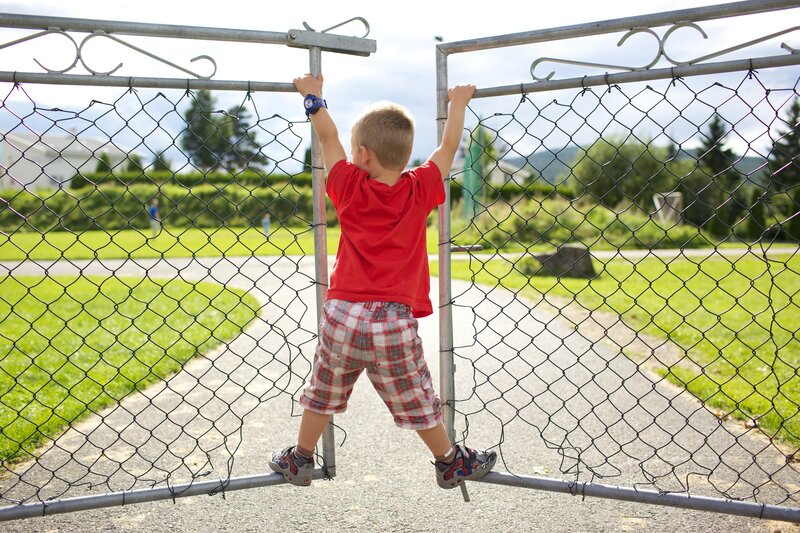 child climbing fence gate