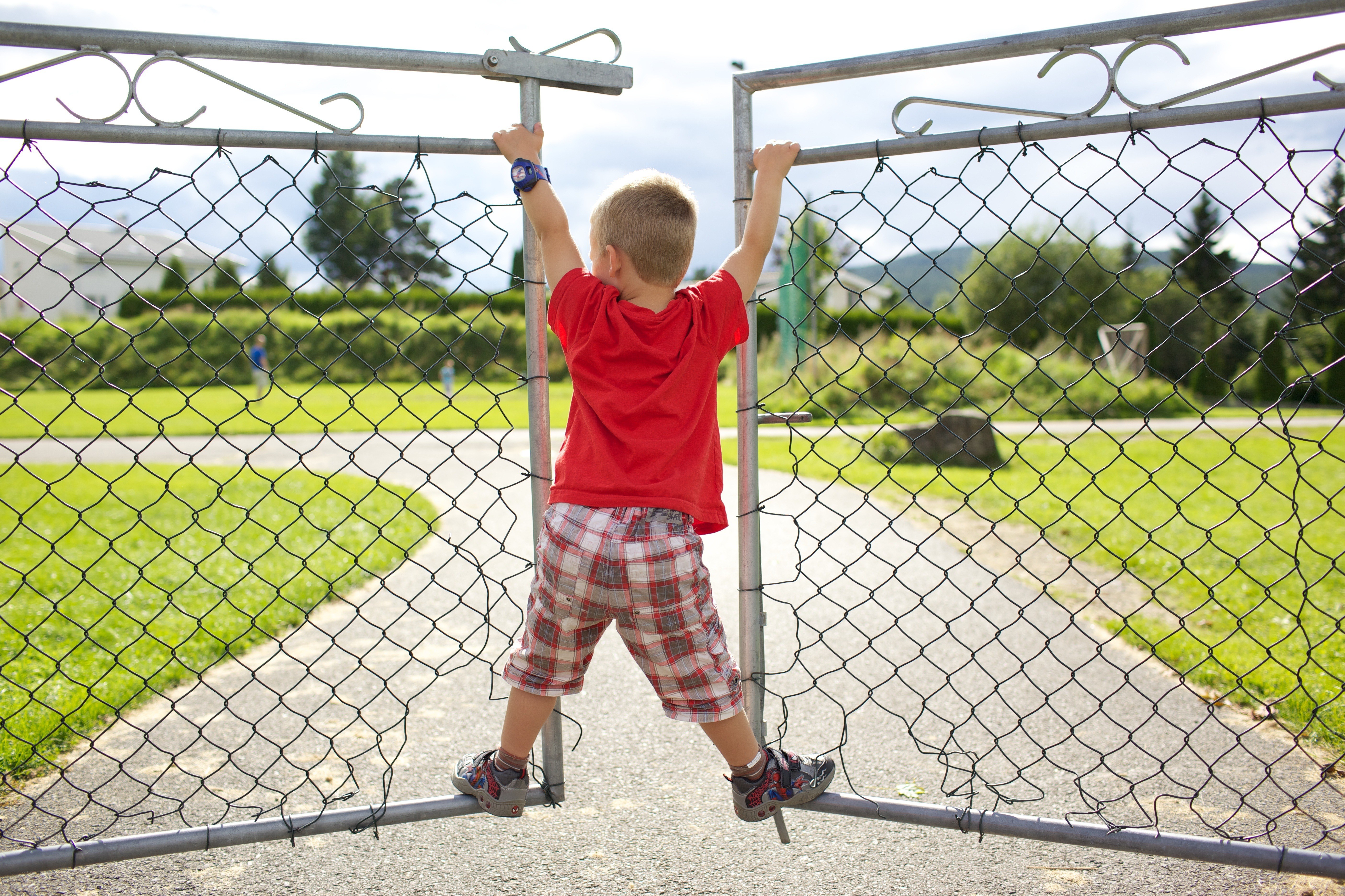 child climbing fence gate