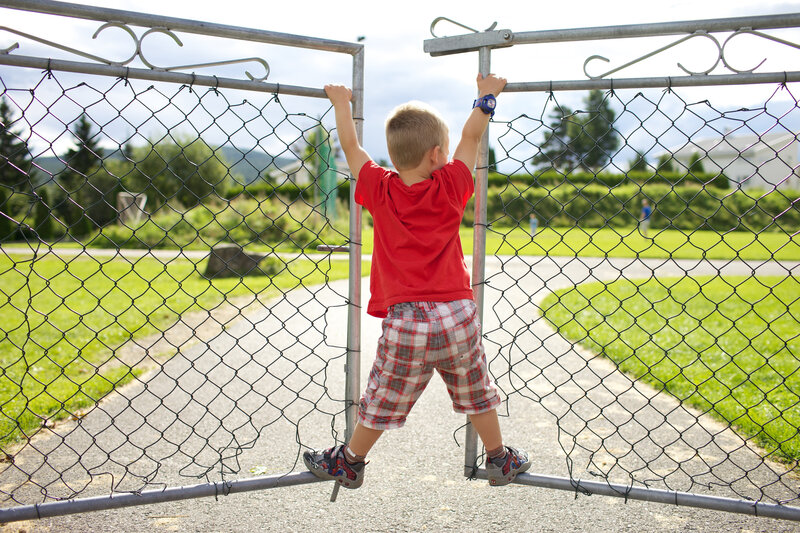 Child Climbing Fence — Red