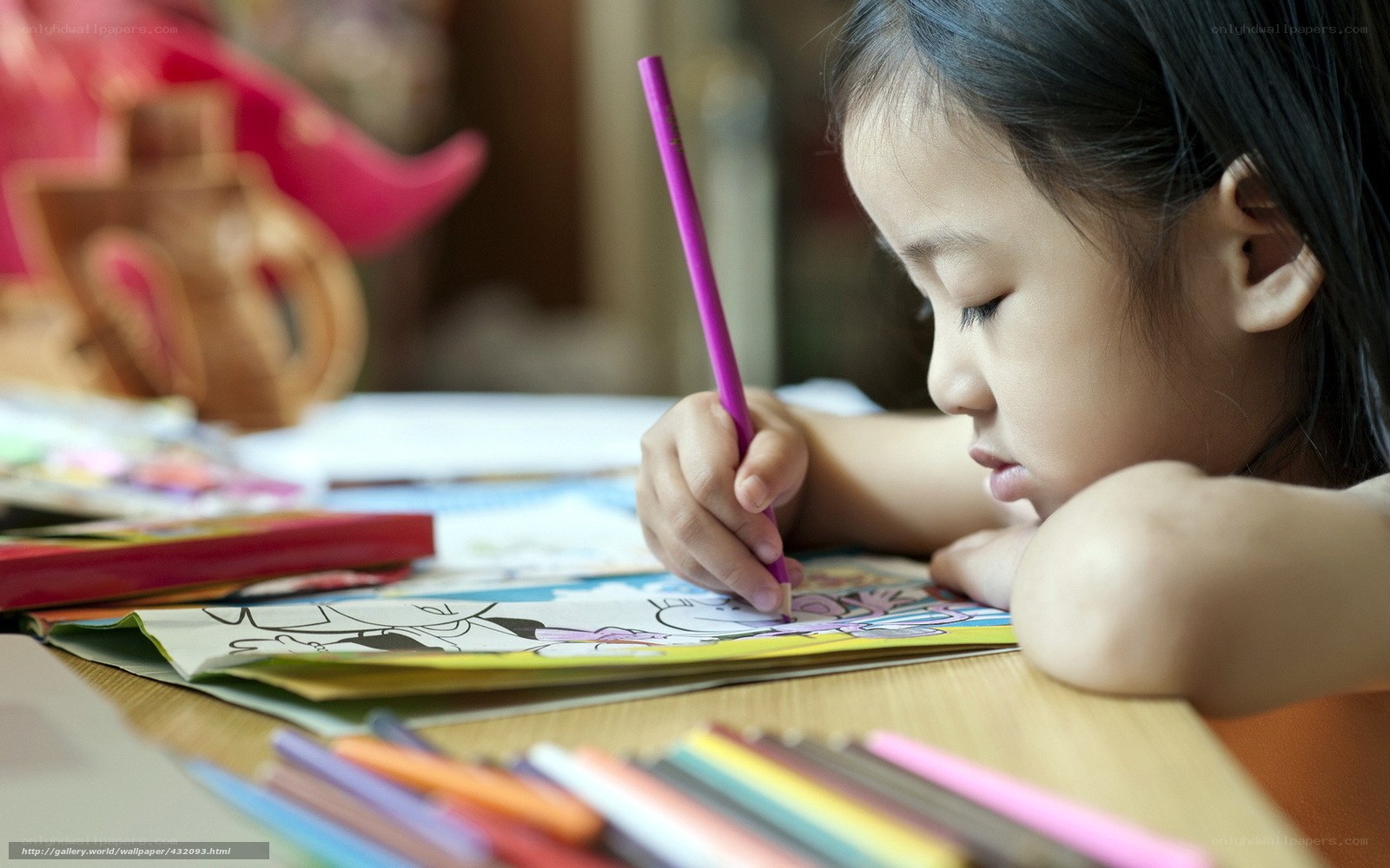 child coloring with crayons